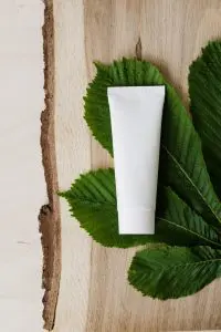 Blank cream tube on fresh chestnut leaf